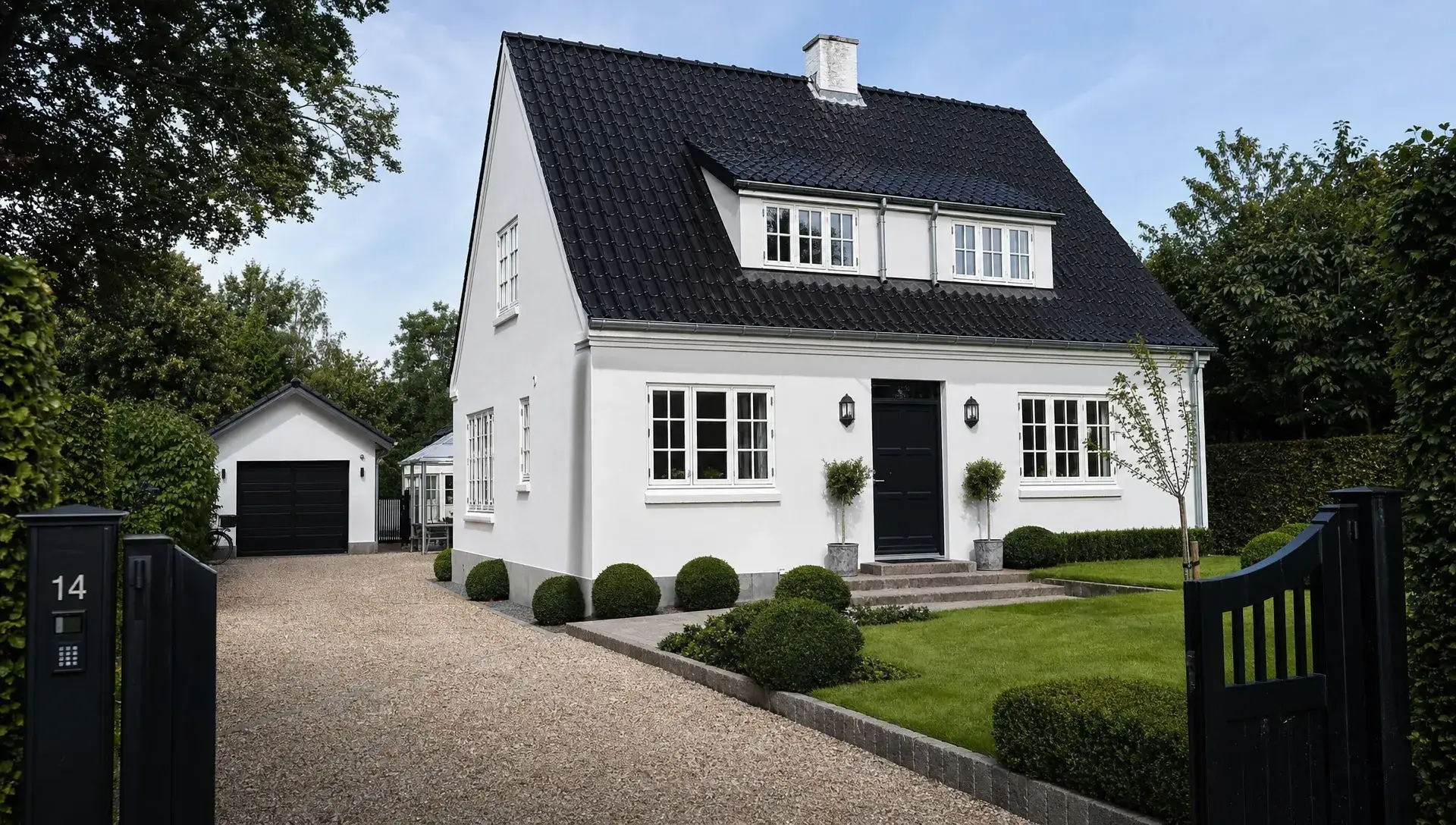 Nymalet dansk hus med lys facade, rene vinduesdetaljer og velholdt træværk set i øjenhøjde fra indkørslen i et roligt villakvarter i Nordsjælland.